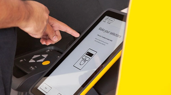 Person pointing the left index finger at a voter tablet 